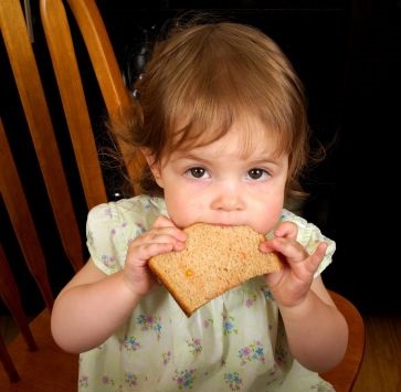 young girl eating toast