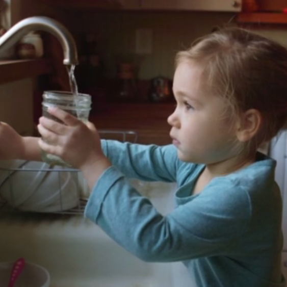 little girl drinking tap water