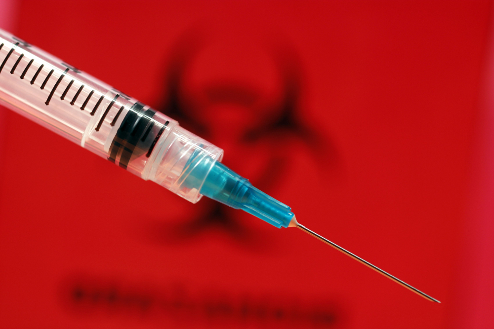 Syringe with biohazard background
