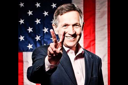 Dennis Kucinich in front of an American Flag