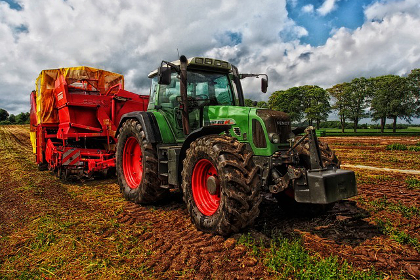 Farm tractor on a sunny crop field