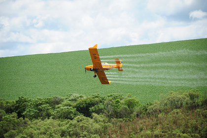 Aerial dispersal of a pesticide over an agricultural field