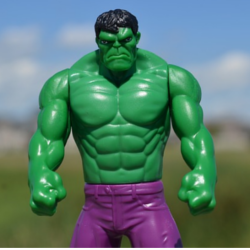 Incredible Hulk action figure standing in a field