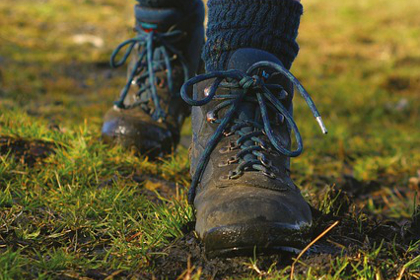 Pair of feet in boots walking along the ground