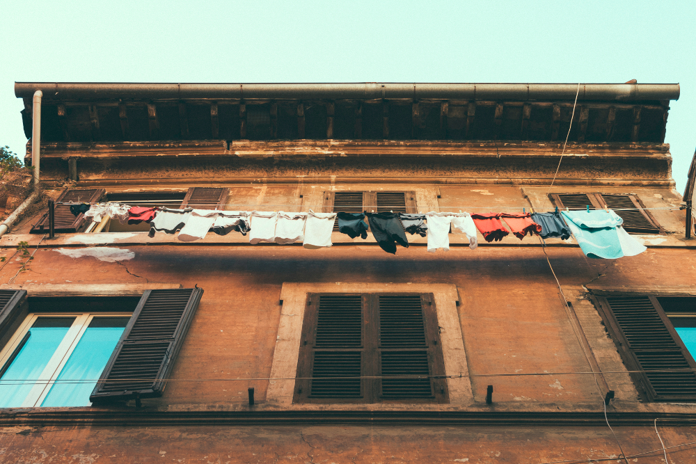 Clothes line with clothes in front of a brick building