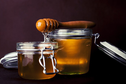 Jars of honey with a dipper