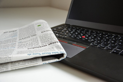 Newspaper and laptop computer