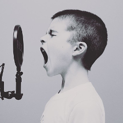 Child yelling into a radio microphone