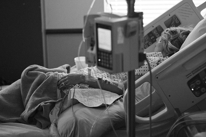 Patient in a hospital bed with monitoring equipment