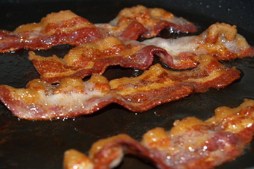 Bacon cooking in a frying pan