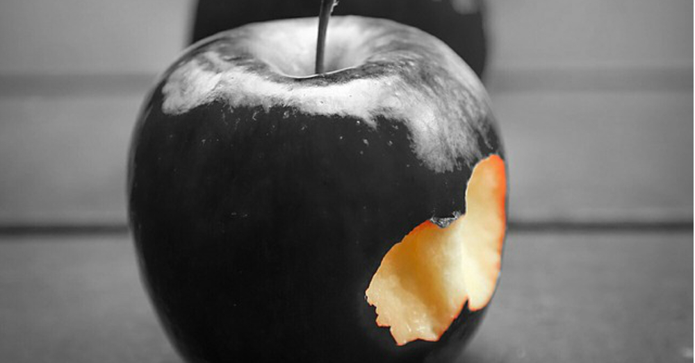 Black apple with a bite taken out