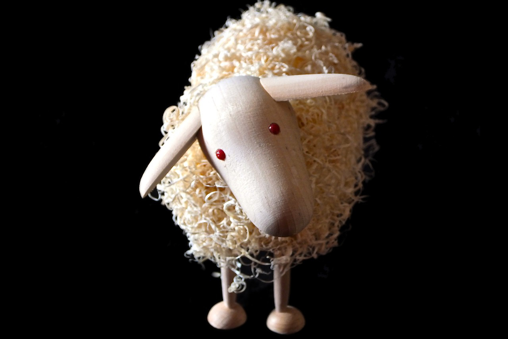 Recycled toy of a wood and wool sheep