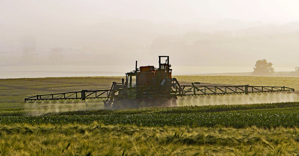 Spraying pesticides on an agricultural farm field