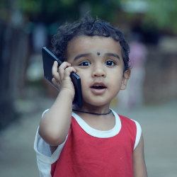Young child making a phone call on a cell phone