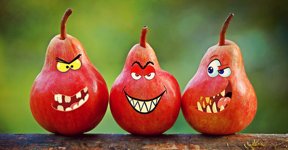 Three red pears with cartoon evil faces