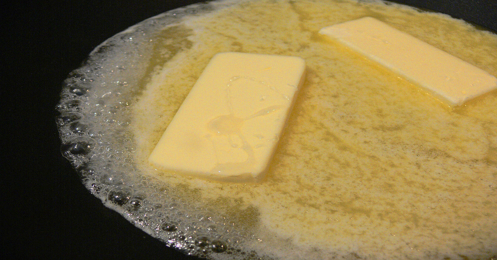 Butter melting in a cast iron pan