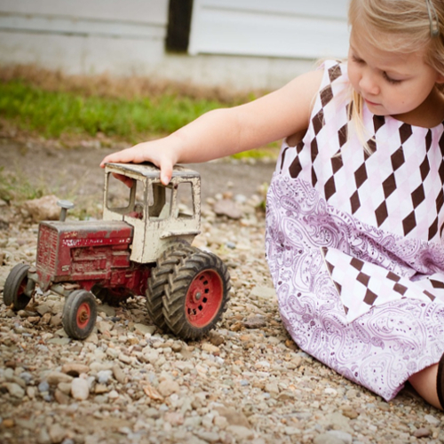 Girl playing with a toy tractor
