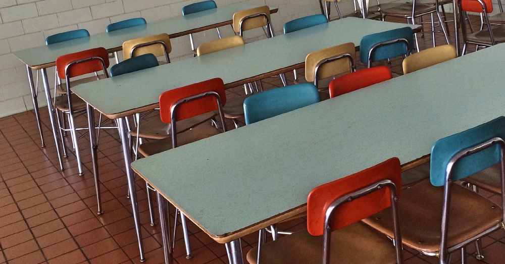Tables and chairs in an empty cafeteria
