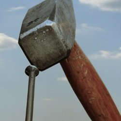 A hammer pounding in a nail