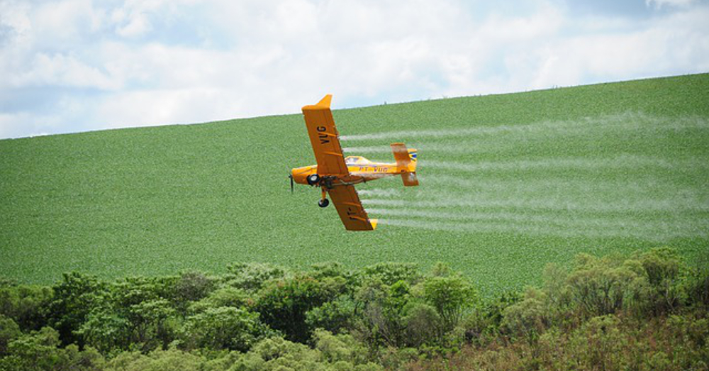 aerial spray of a pesticide or herbicide to an agricultural crop field
