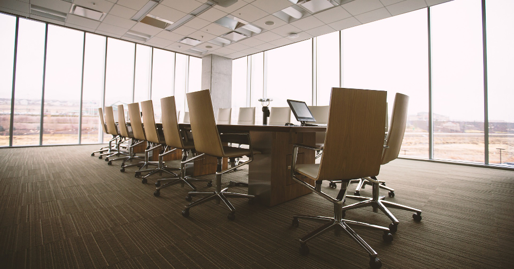 empty chairs around a conference table in a meeting room