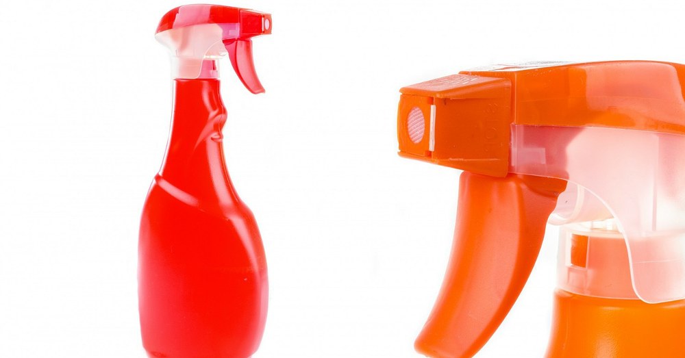 two household sprayer bottles in orange and red