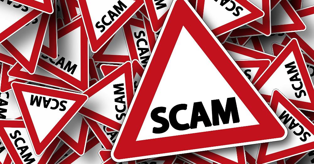 white and red warning signs of a scam