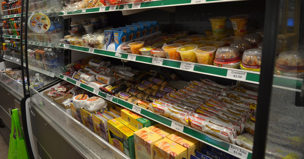supermarket shelving in the produce section featuring packaged food