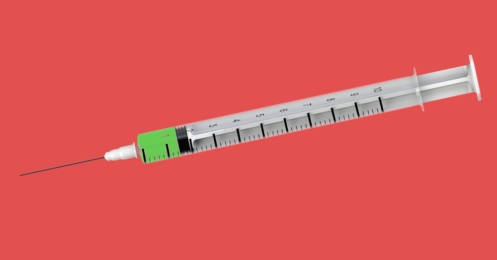 vaccination syringe filled with green fluid