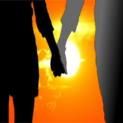 silhouette of two people holding hands at sunset