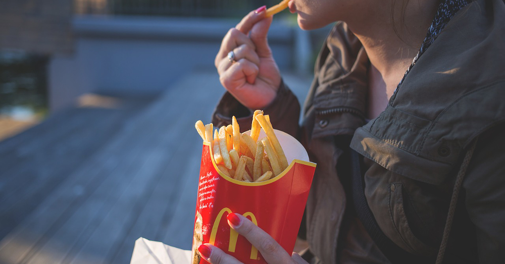 person eating McDonalds french fries