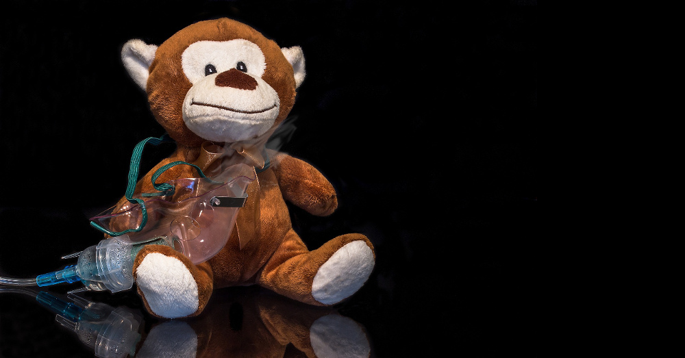 teddy bear stuffed animal with an oxygen mask inhaler