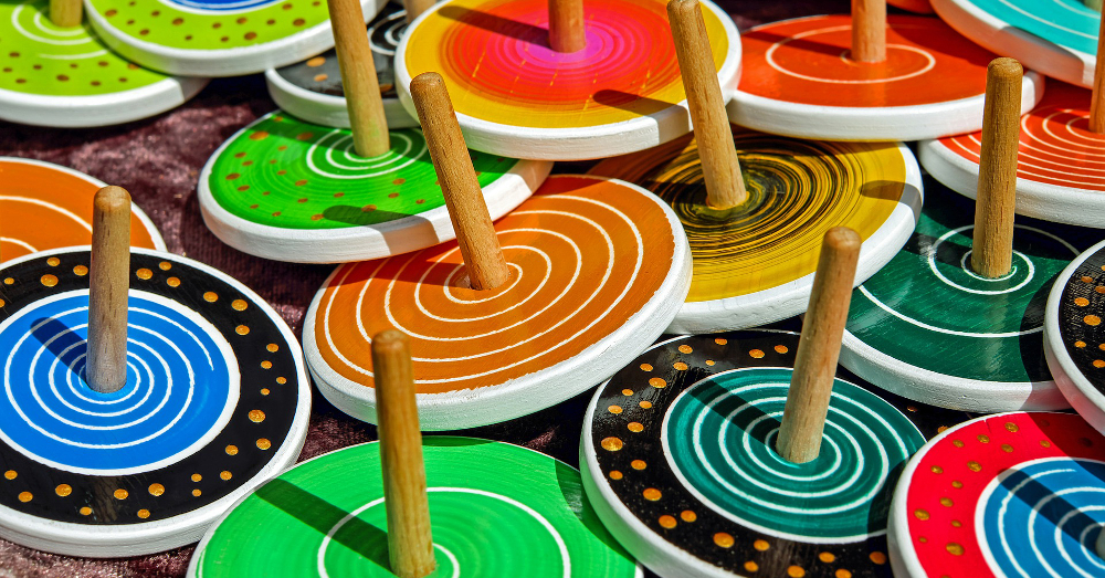 several colorful wooden toy tops