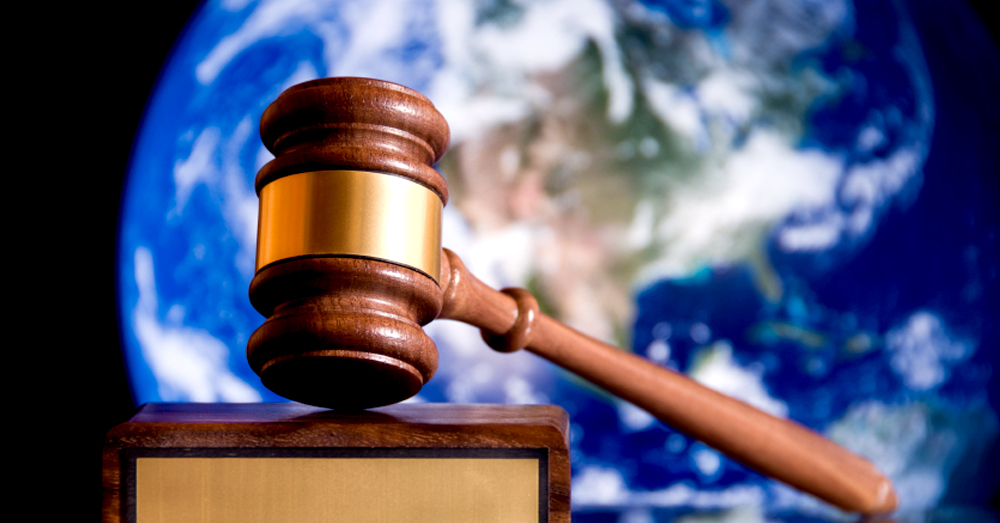 gavel with image of earth behind it