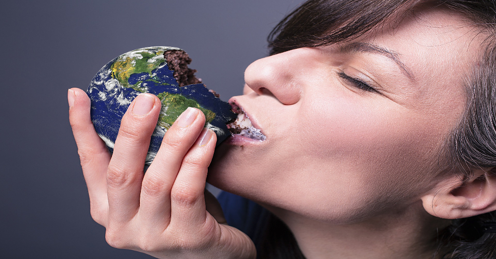 woman eating a pastry in the shape of the earth
