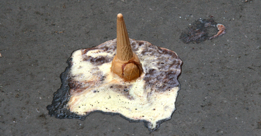 upside down ice cream cone melting on pavement