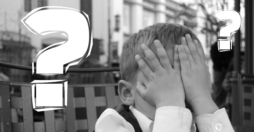 child covering their eyes with question marks hovering around their head