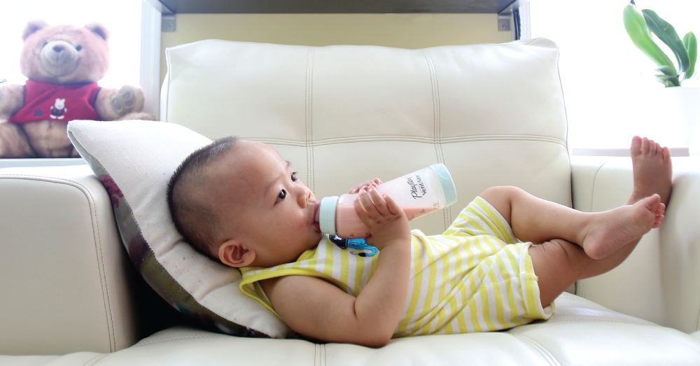 Baby drinking from a bottle.