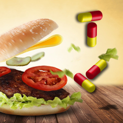 burger with flying ingredients surrounded by pill capsules