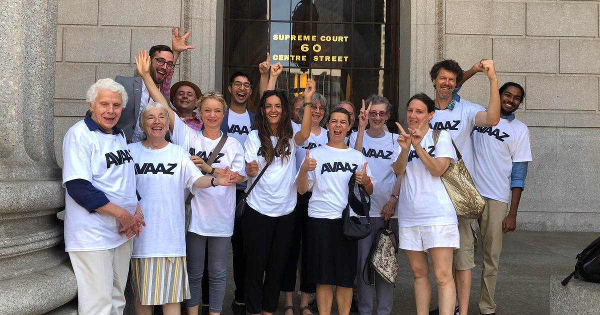 Avaaz members outside courthouse steps