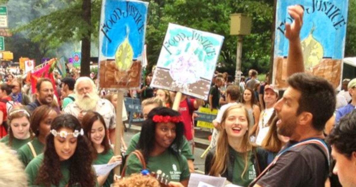people holding signs during the Peoples Climate March protest