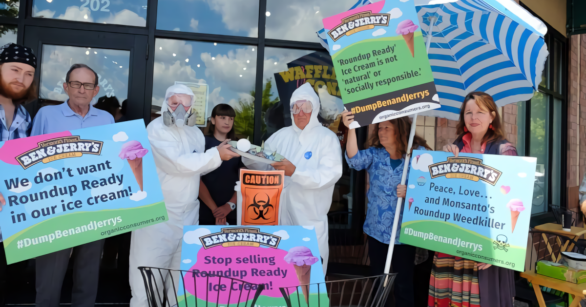 protesters in front of a Ben and Jerrys dumping ice cream into buckets