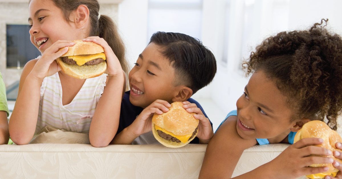 Kids eating burgers.