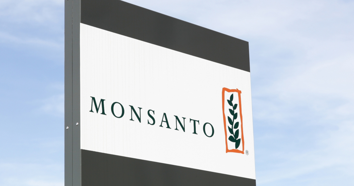 Monsanto logo on a sign against a cloudy blue sky