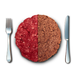 hamburger of half beef and half plant on a white table with a fork and knife