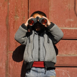 young boy with a pair of binoculars