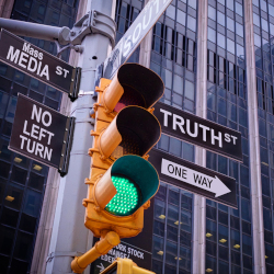 traffic light in NYC with signs pointing to MASS MEDIA and TRUTH