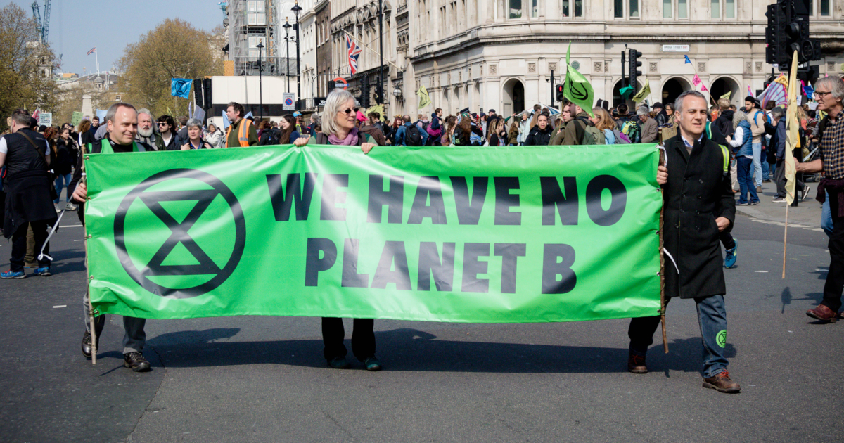 many people marching in the street protesting climate change