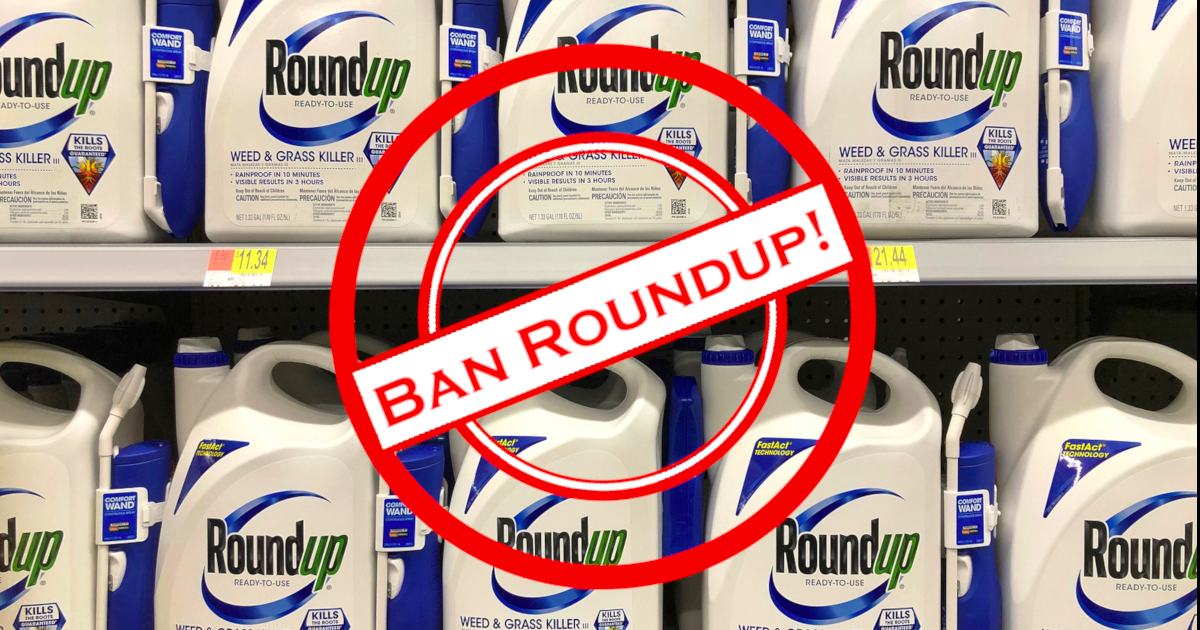 Ban Roundup symbol over top of shelf of Roundup bottles