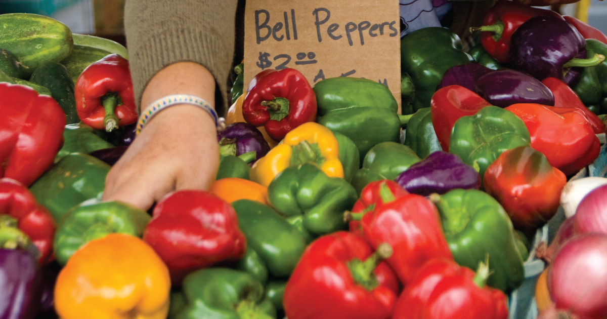 Bell peppers being sold at a farmers market.